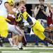 Michigan senior junior quarterback Denard Robinson tackles Alabama junior Dee Milliner after Robinson threw an interception during the first quarter of the Cowboy Classic at Cowboy Stadium in Arlington, Texas on Saturday. Melanie Maxwell I AnnArbor.com